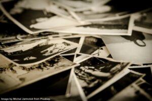 pile of old photographs representing conquer photo clutter