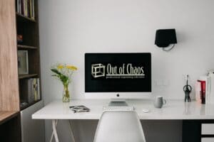 HR Matters article tidy desk with Out of Chaos logo on computer