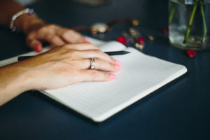 woman writing in Christmas planner is one of my favourite holiday organizing tips