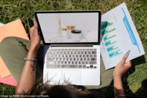 person working on their computer outside using a portable office for productivity