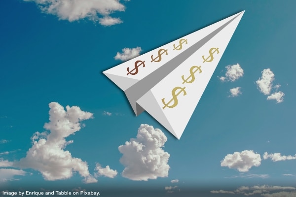 a paper airplane with dollar signs on it flying high into the sky representing how the assistance of financial professionals can boost your productivity and success