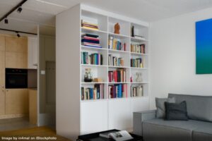 white bookshelf in modern apartment stylized to look less messy