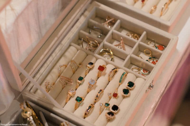 rings and earrings displayed in jewelry box representing the art of jewelry organizing