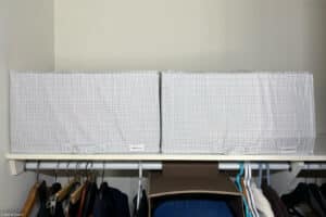 two collapsible storage boxes (IKEA STUK) on a closet shelf